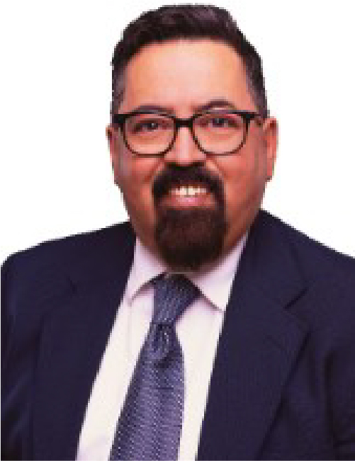Smiling man in glasses and suit.