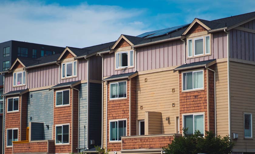 Row of modern multi-story townhomes.