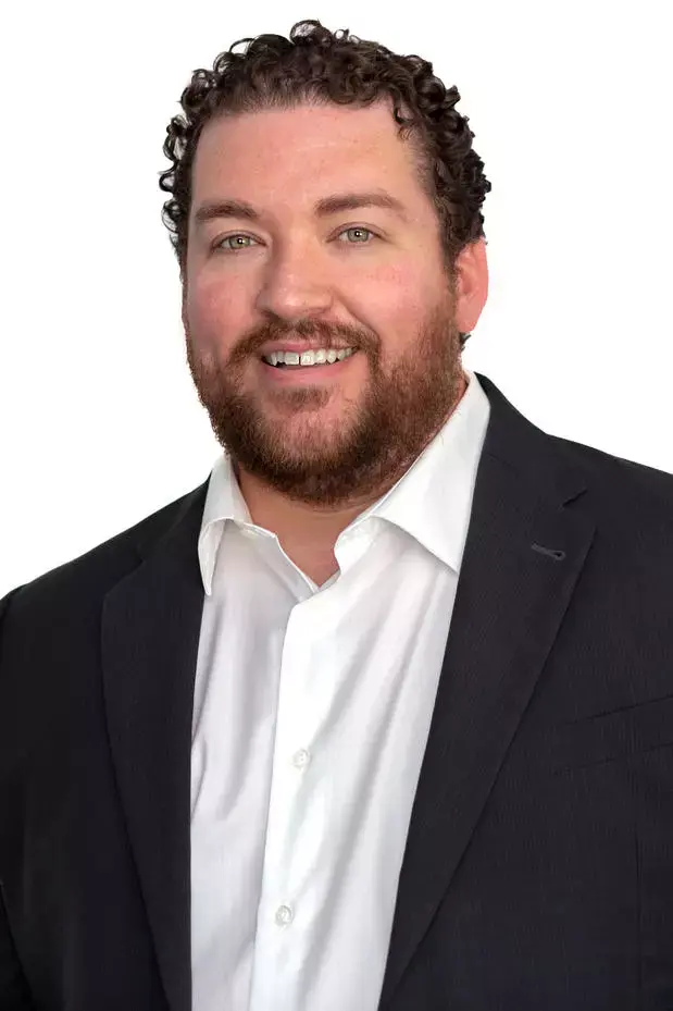 Smiling man in suit jacket portrait.