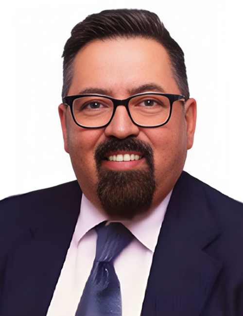 Smiling man in glasses and suit.